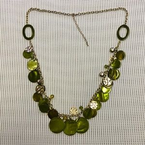 Long necklace with green and metallic charms